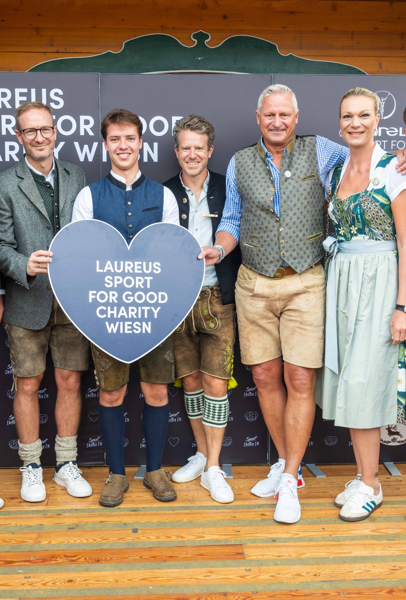Guests in traditional Bavarian attire at the Laureus Sport for Good Charity Wiesn